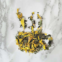 Load image into Gallery viewer, Tea cup-shaped leaves of a tea blend featuring Calendula Marigold Petals, Nettle Leaf and Lemon Balm for our Menstruation Tea