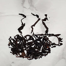 Load image into Gallery viewer, Loose black tea leaves for English Breakfast tea on a marble surface.