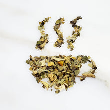 Load image into Gallery viewer, Tea cup-shaped leaves of a tea blend featuring mixture of Turmeric root, Yerba Mate and Orange Peel for our Energy blend Revive