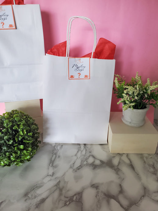 A beautifully wrapped Mystery Bag filled with a surprise selection of tea, self-care products, and unique accessories.

Embrace the surprise—grab your Mystery Bag today and see what’s inside!